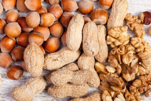 Preview: Different type of nuts on wooden background