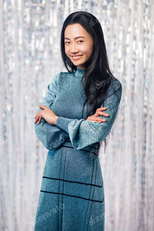 Preview: Portrait of happy asian woman with crossed arms