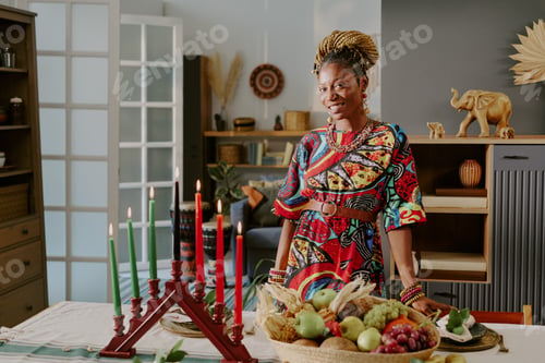 Preview: Portrait of Young Adult Black Woman Celebrating Kwanzaa with Festive Table