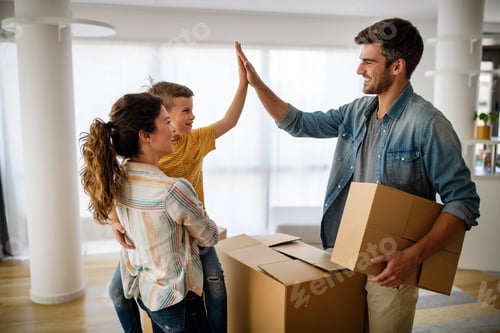Preview: Happy family with children moving with boxes in a new apartment house