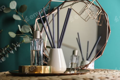 Preview: Composition with stylish accessories and interior elements on table near turquoise wall