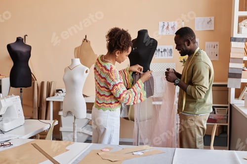 Preview: Two young African American couturiers standing by mannequin