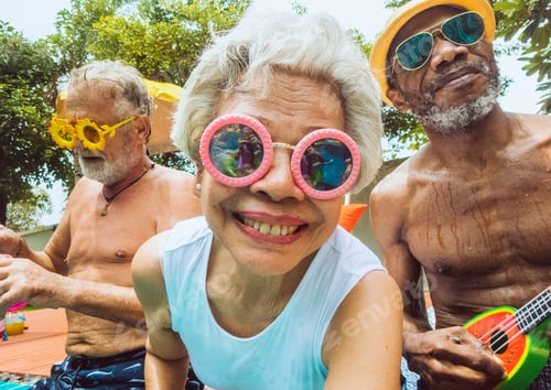 Preview: Closeup of diverse senior adults sitting by the pool enjoying summer together