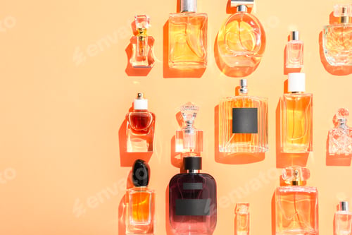 Preview: Different luxury perfumes on beige background, flat lay. Space for text