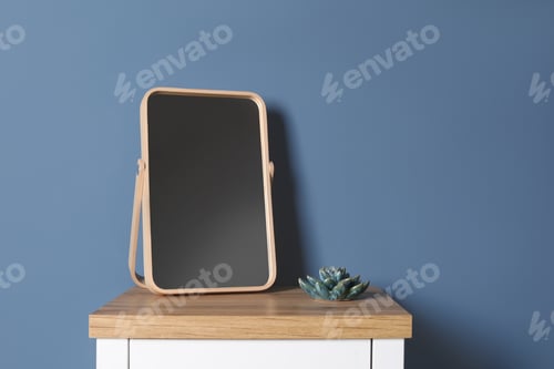Preview: Modern mirror on table near color wall