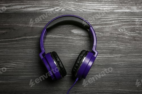 Preview: Stylish headphones on wooden background, top view
