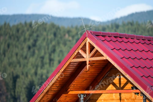 Preview: Close-up detail of new modern house top with shingled red roof and wooden sidings
