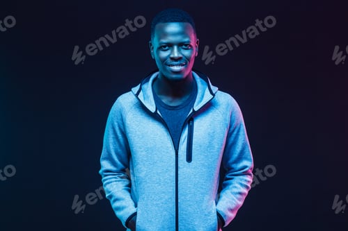 Preview: Neon portrait of smiling african man wearing gray hoodie