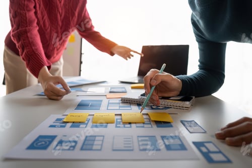 Preview: Close up ux developer and ui designer brainstorming about mobile app interface wireframe design at