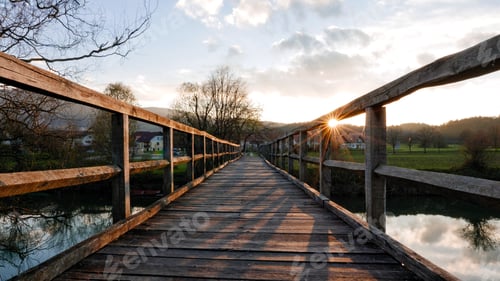 Preview: A wooden footbridge over a river.