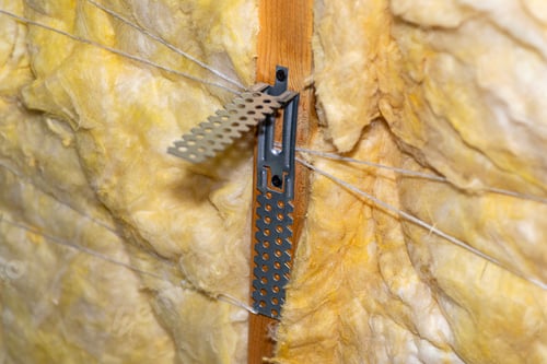 Preview: Aluminum frame with hangers placed on beams in the attic for mounting plasterboards.