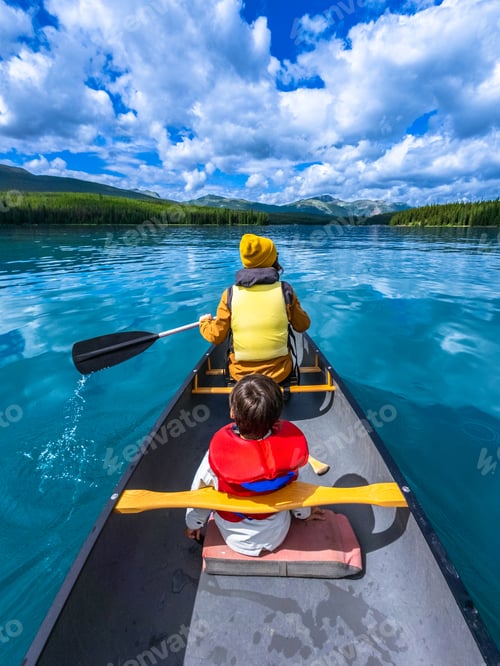Preview: Father and son canoeing on maligne lake in jasper national park, alberta, canada