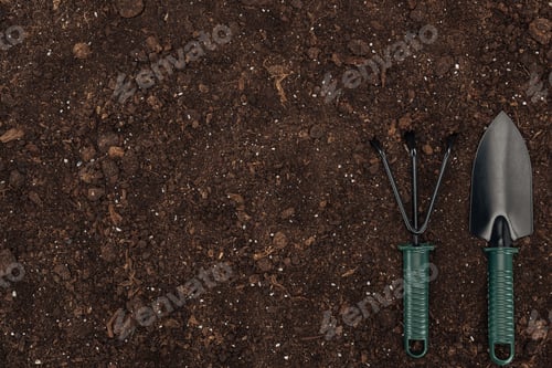 Preview: top view of shovel and rake on ground, protecting nature concept