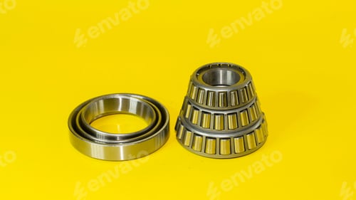 Preview: Closeup shot of ball bearings isolated on a yellow background
