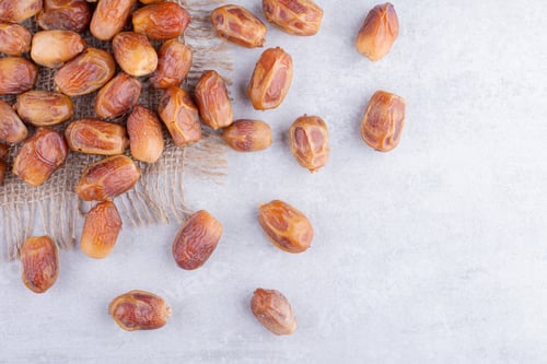 Preview: Yellow dates isolated on concrete background