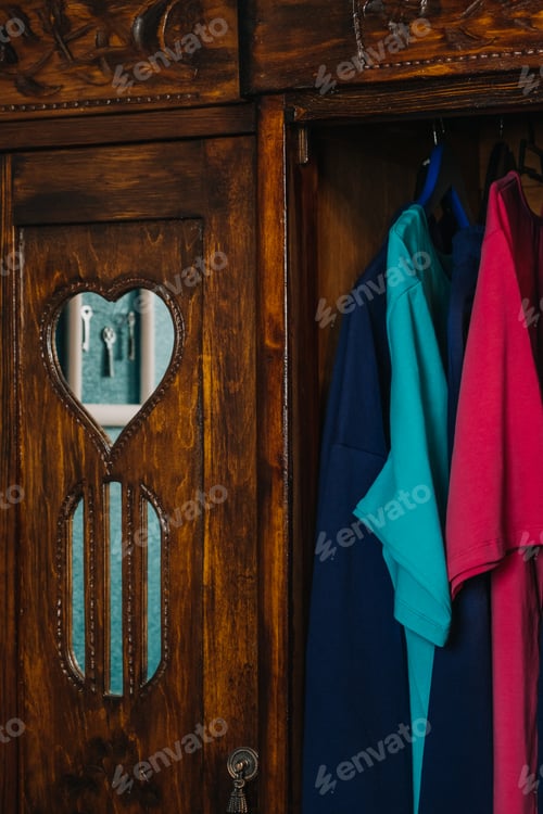 Preview: Ornate Wooden Cabinet with Colorful Shirts Inside