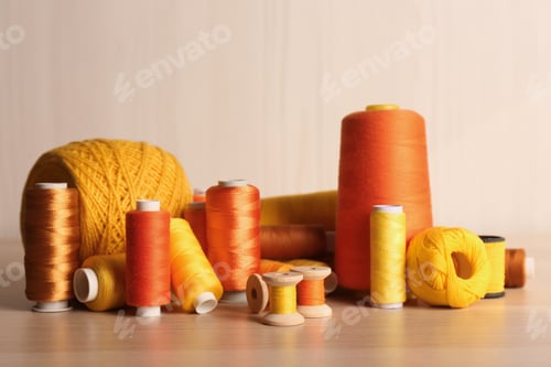 Preview: Set of color sewing threads on wooden table