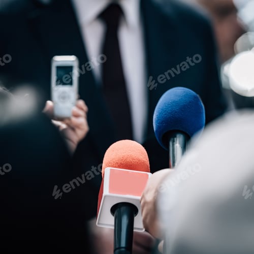 Preview: Media interview, a politician talking, reporters holding microphones