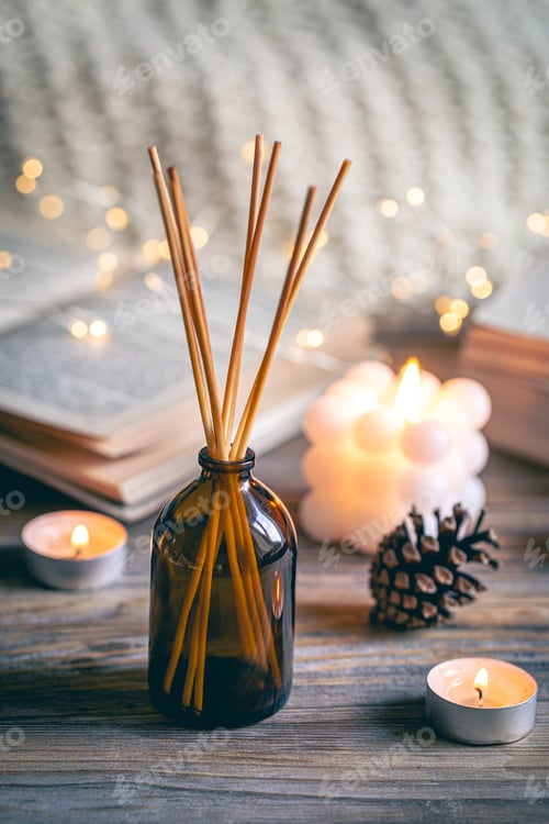 Preview: Winter spa composition with incense sticks, candles and bokeh lights.