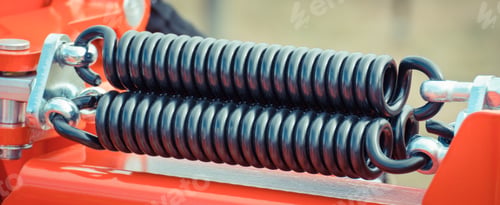 Preview: Hard black spring made of steel. Part and detail of industrial or agricultural machine
