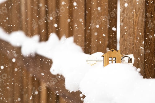 Preview: Key to the house on a wooden fence in winter in the snow. A gift for New Year, Christmas