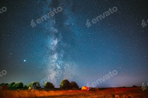 Preview: Milky Way Galaxy In Night Starry Sky Above Haystack In Summer Agricultural Field. Night Stars Above