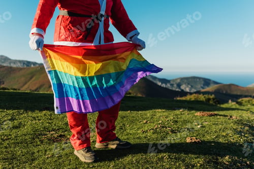Preview: santa claus holding a rainbow lgbt pride