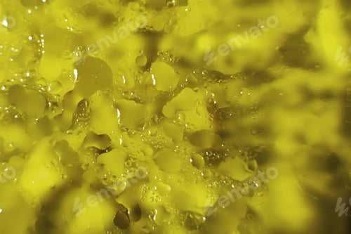 Preview: water drops on a yellow background. Abstract yellow background. Water drops on glass.