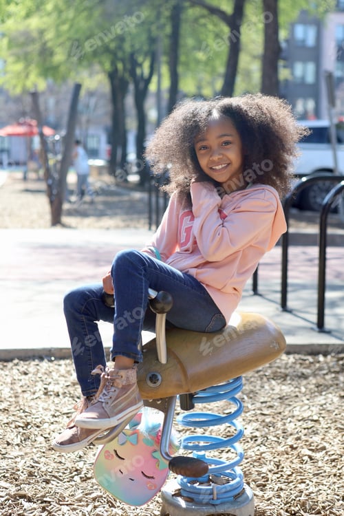 Preview: a girl sitting on a swing with her legs spread out