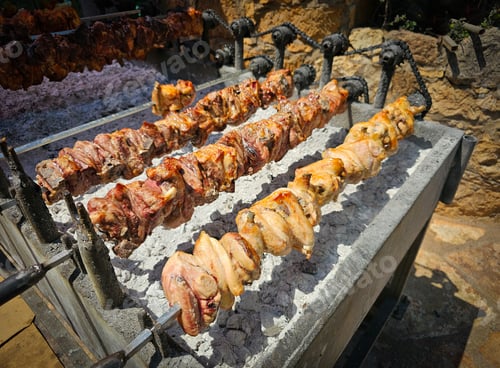 Preview: Pork lamb and chicken meat cooked traditionally on a charcoal bbq grill . Cyprus traditional souvla