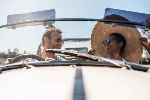 Preview: Multiracial couple in a convertible vintage car