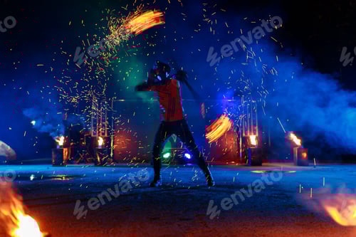 Preview: Fire show, dancing with flame, draws a fiery figure in the dark, bright sparks in the night.