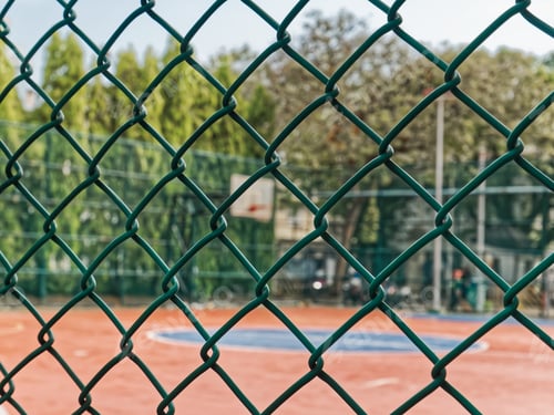 Preview: Close-up Green Wire Mesh Metal Fence Around the Basketball Field