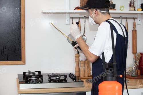 Preview: Person disinfecting the kitchen under the lights - coronavirus concept