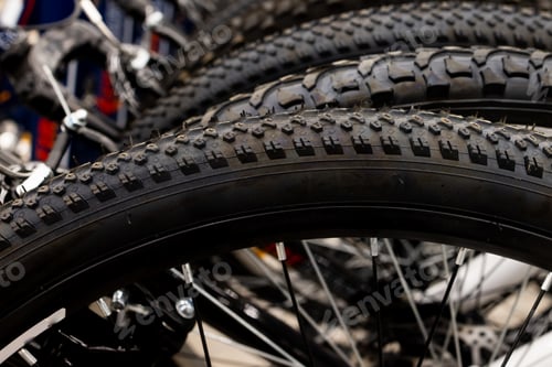 Preview: store has a new assortment of bicycle tires in storage, a stack of black tires.