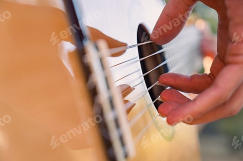Preview: Close-up of the musician's playing hands. The guitarist plays the guitar.