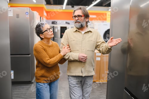 Preview: Senior couple choosing appliance at electronics store