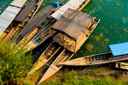 Preview: Aerial shot of wooden boats parked in the shore of a lake during daytime