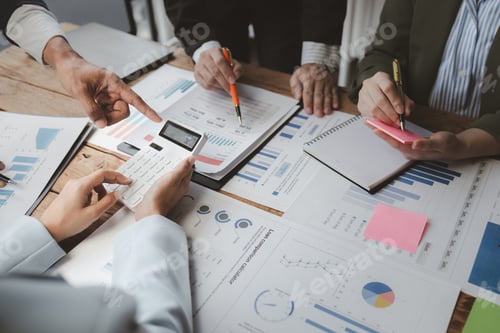 Preview: Business Professionals Reviewing Financial Data and Loan Calculator