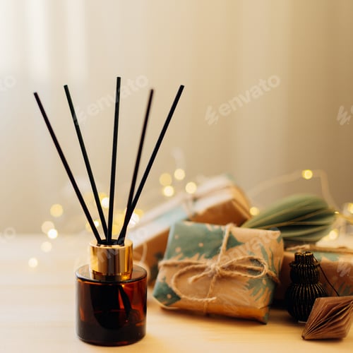 Preview: Home winter aroma fragrance diffuser on wooden table. Interior elements.