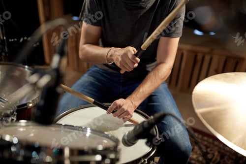 Preview: male musician playing drums and cymbals at concert
