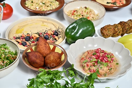 Preview: a table that has a variety of food on it including olives, carrots
