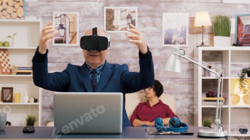 Preview: Senior man using virtual reality goggles in living room