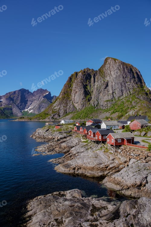 Preview: Red Cabins Nestled Among Norwegian Mountains, Hamnoy fishing village on Lofoten Islands, Norway