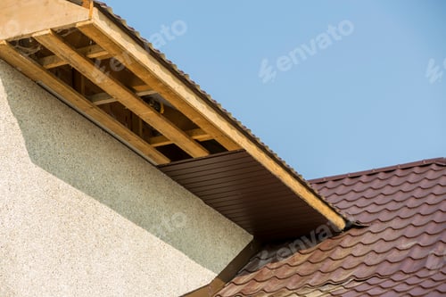 Preview: Bottom view detail of new modern house cottage corner with stucco walls, brown shingled roof and
