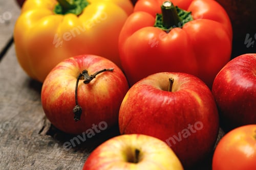 Preview: Pile of apples and bell peppers on wooden table