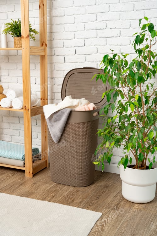 Preview: Pile of clothes in plastic laundry basket in the bathroom