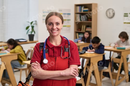 Preview: Portrait of Caucasian Young Adult Woman Paramedic Standing in Classroom