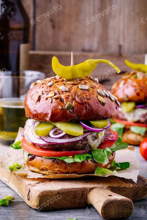 Preview: homemade burger with whole grain bun and spicy pickled peppers