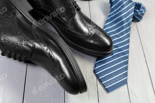 Preview: shoes and accessories for men lay on the wooden floor